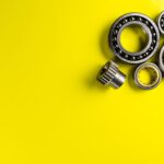 ball-bearing-lying-on-a-yellow-background-with-cop-2023-11-27-04-51-46-utc